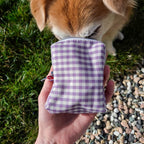 Detail d'un petit chien fouillant avec son museau dans la mini sacoche pour chien Cigalou et son motif vichy lavande et blanc 