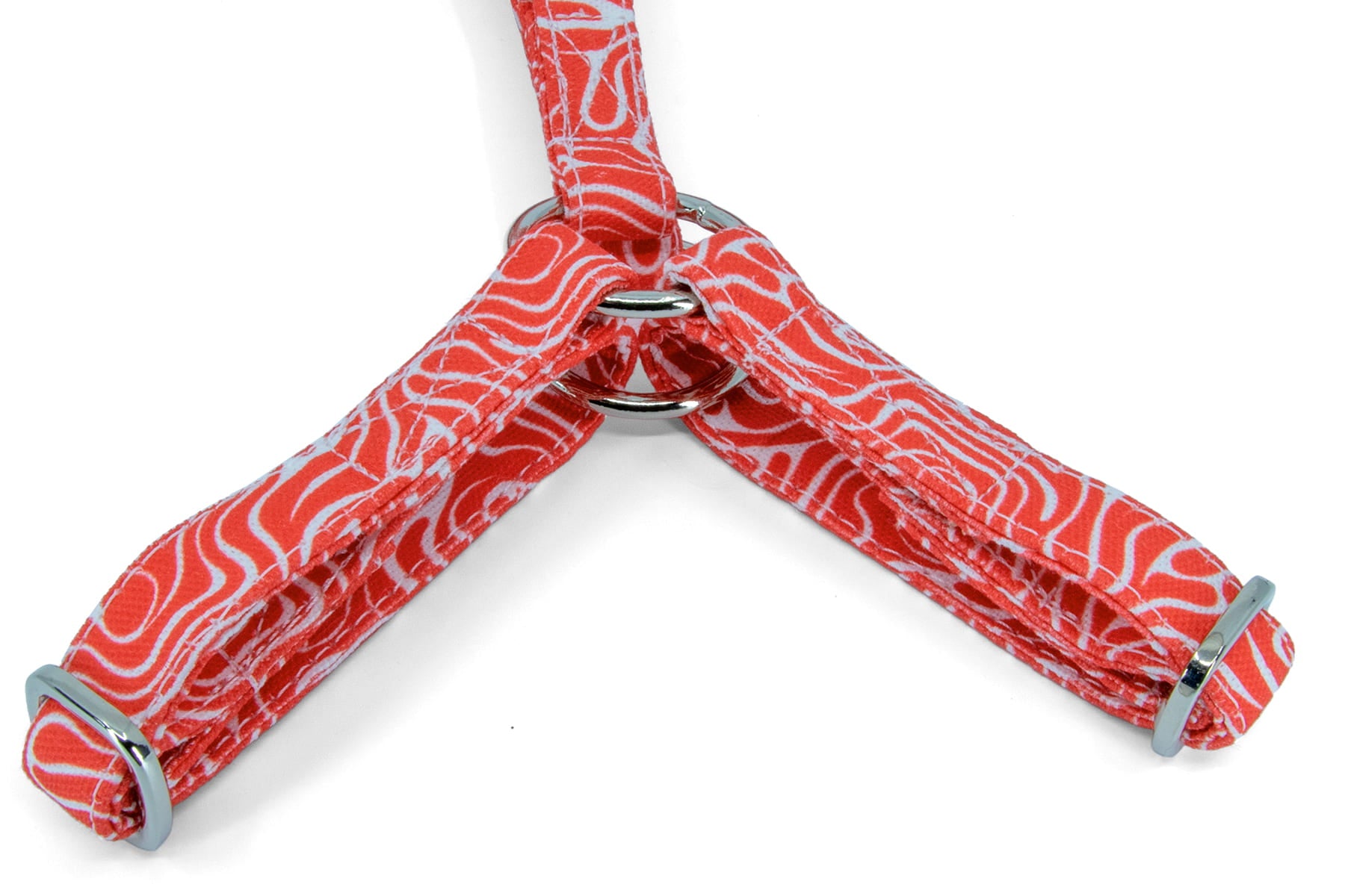 Gros plan de la forme Y du harnais pour chat Cherry de Pawpix. Motif rouge et blanc wavy avec des boucles couleur argent. 