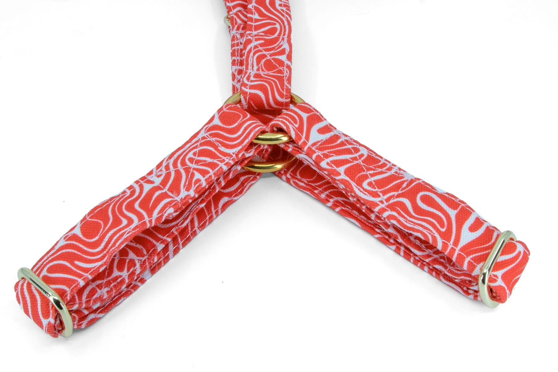 Gros plan du Y du harnais en Y pour chien Cherry de Pawpix. Motif rouge et blanc wavy avec des boucles couleur or. 