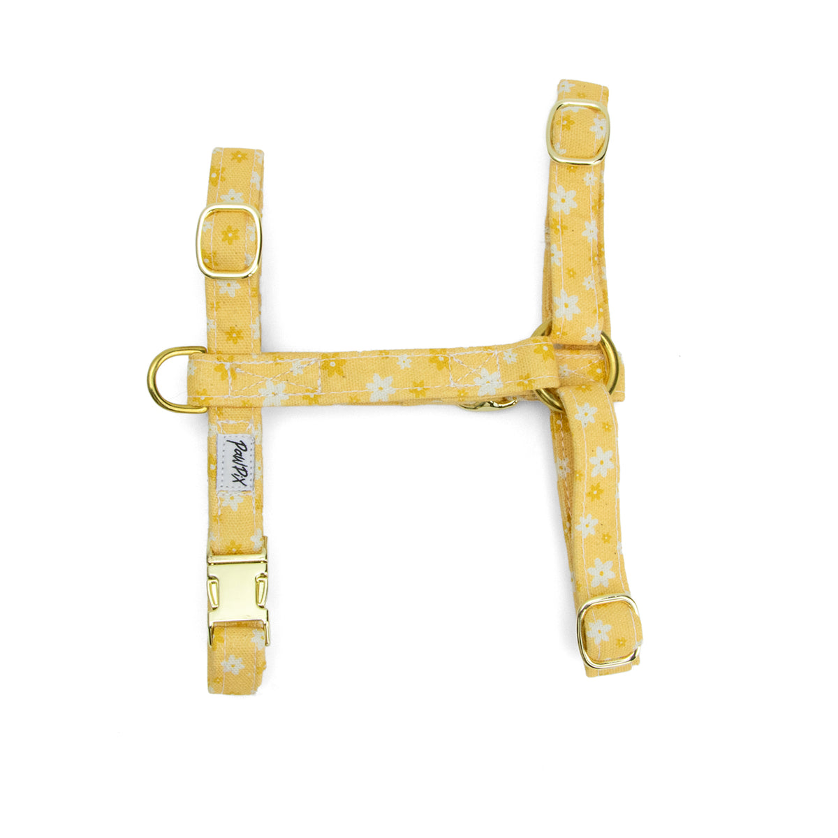 Harnais pour chat Peachy Daisies de Pawpix et son motif marguerites blanches et jaune sur fond couleur pêche. Le harnais est en forme de H et intègre un anneau en D, 4 boucles de reglages, et une boucle clips. Disponible en 2 tailles et fabriqué en france