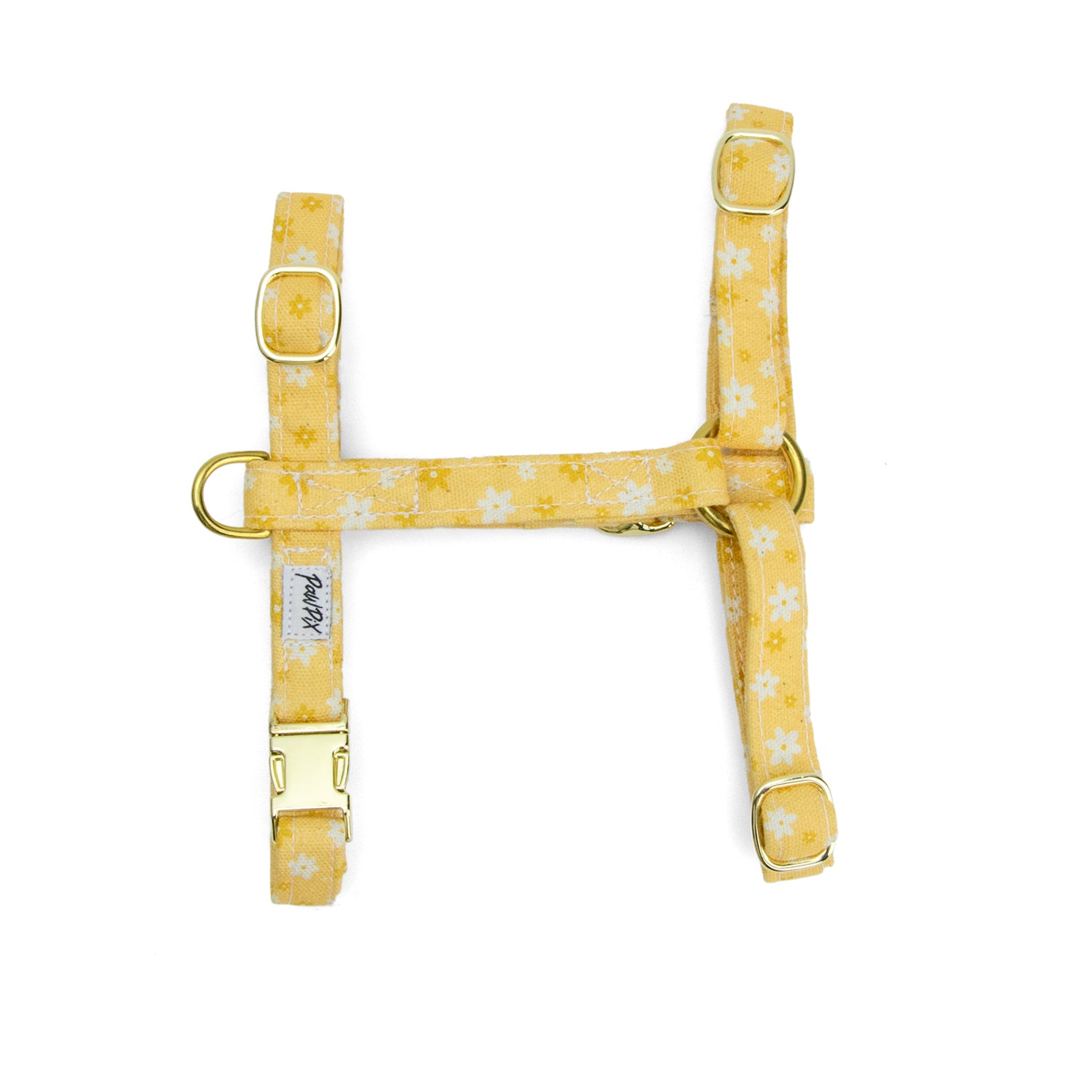 Harnais pour chat Peachy Daisies de Pawpix et son motif marguerites blanches et jaune sur fond couleur pêche. Le harnais est en forme de H et intègre un anneau en D, 4 boucles de reglages, et une boucle clips. Disponible en 2 tailles et fabriqué en france