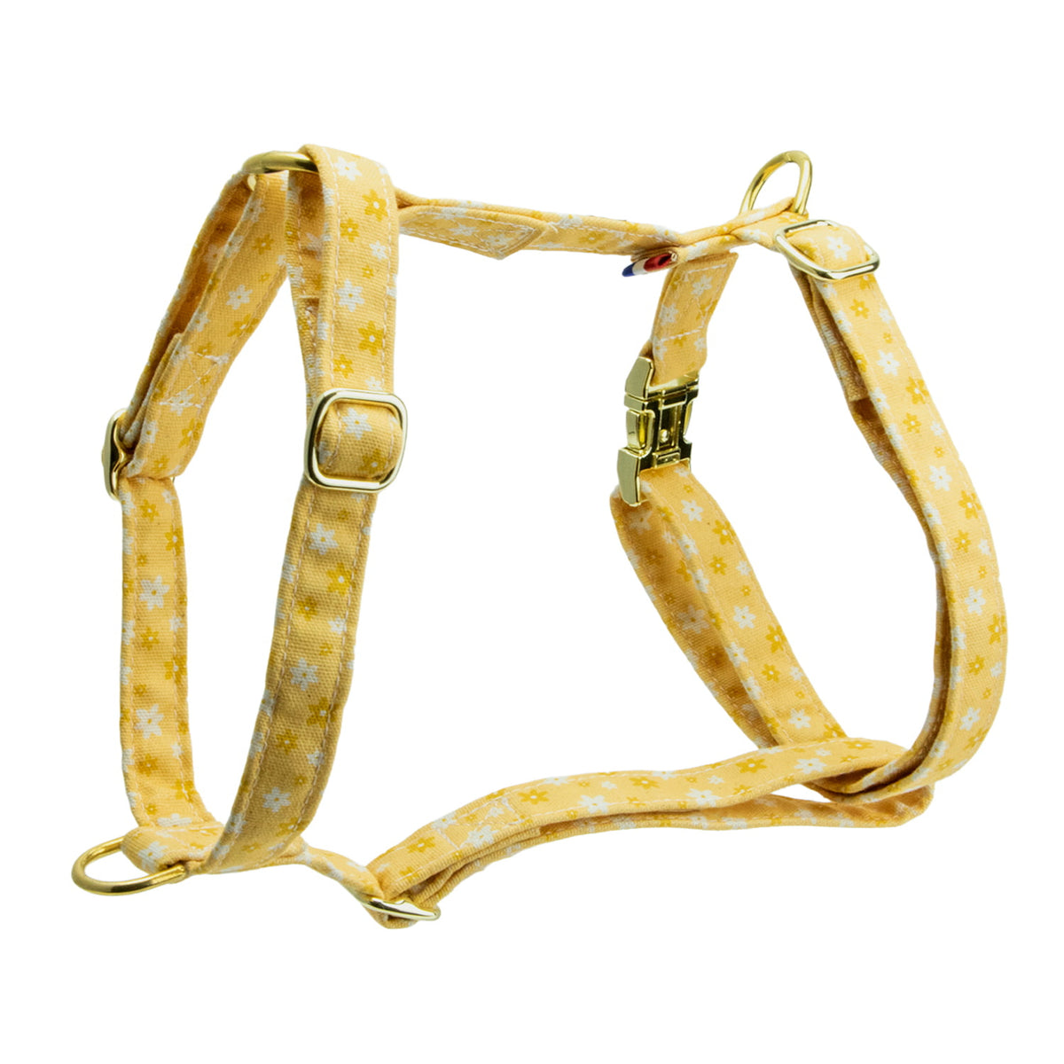 Harnais pour chien Peachy Daisies et son motif marguerites blanches et jaunes sur fond couleur pêche. Harnais en H possèdant une boucle anti-traction et un anneau D,  4 boucles de reglages, et une boucle clips. Le harnais est disponible en 4 tailles et est fabriqué en France