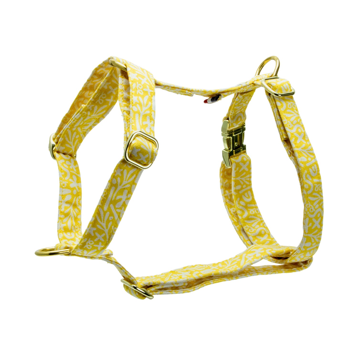 Harnais pour chien Seaside suspendu avec son motif marin abstrait blanc sur fond jaune. Le harnais est en H et anti-traction. Il possède également 4 boucles de réglages, une boucle clips et un anneau en D couleur or.  