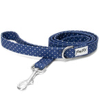Laisse Polaris. Design bleu marine avec des pois blancs avec un anneau en D argenté pour accrocher une pochettes sac à crottes et un mousqueton pour accrocher la laisse. 