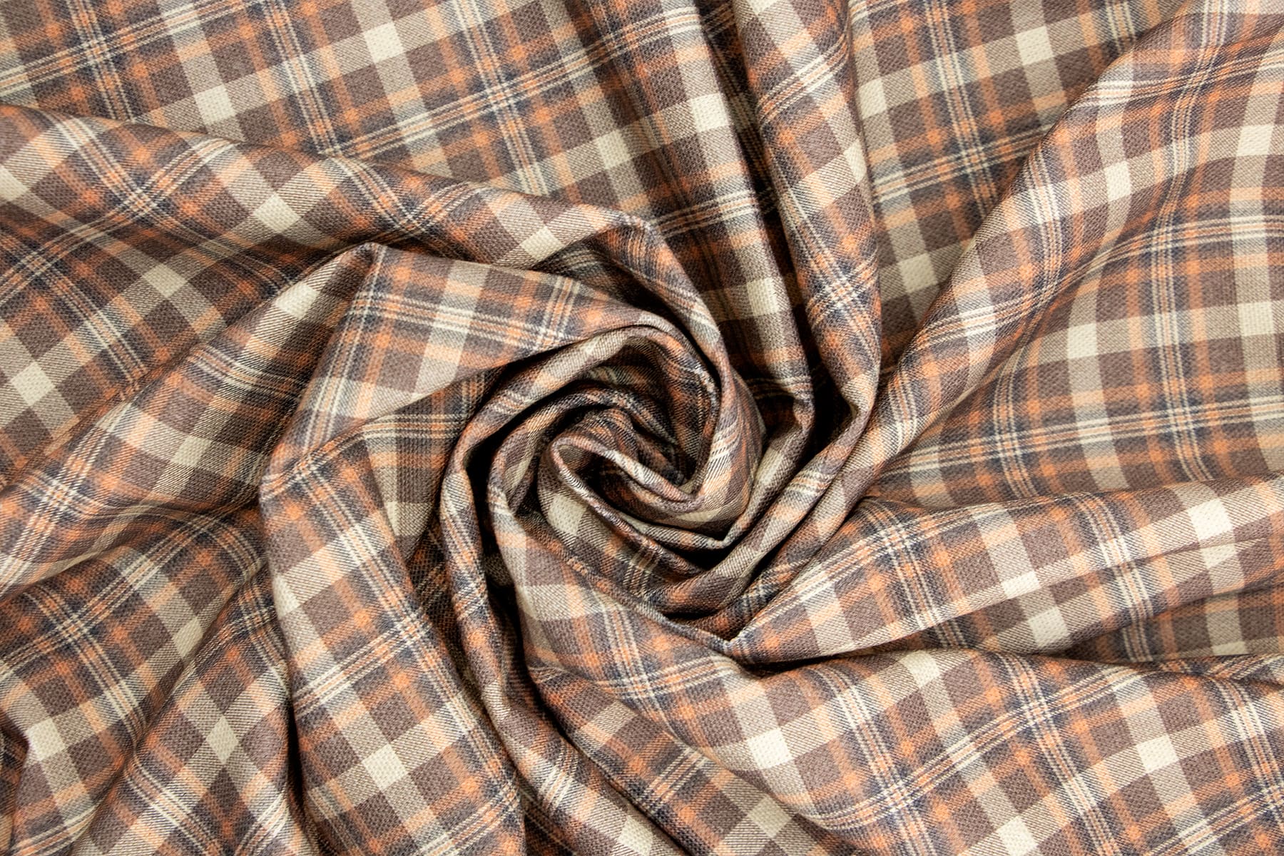 Gros plan sur le tissu Scotty et son motif tartan marron, orange. Le tissu sert pour la confection des accessoires pour chiens et chats